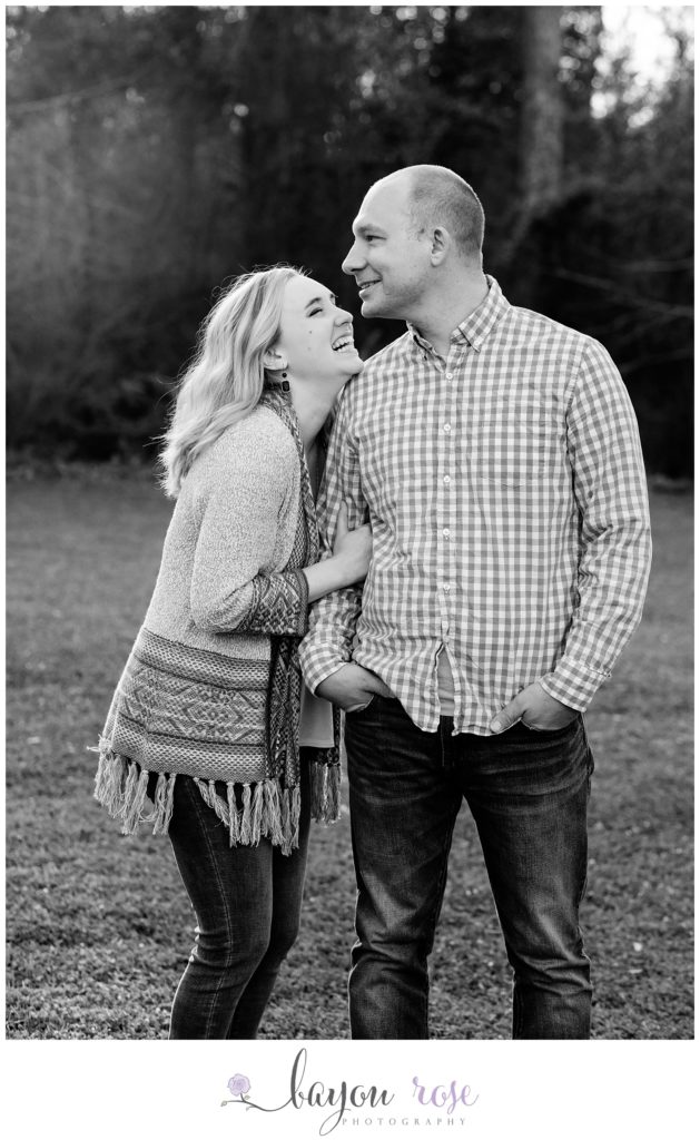 black and white image of couple laughing in engagement photo