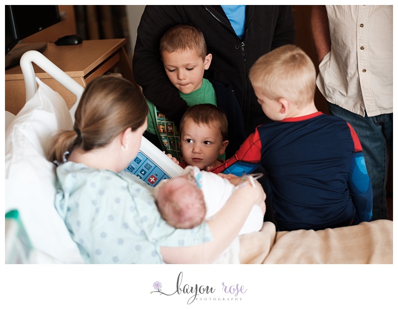 siblings meeting newborn baby brother