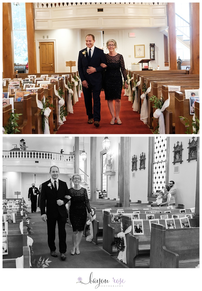 groom and mother walking down church aisle filled with photos of guests