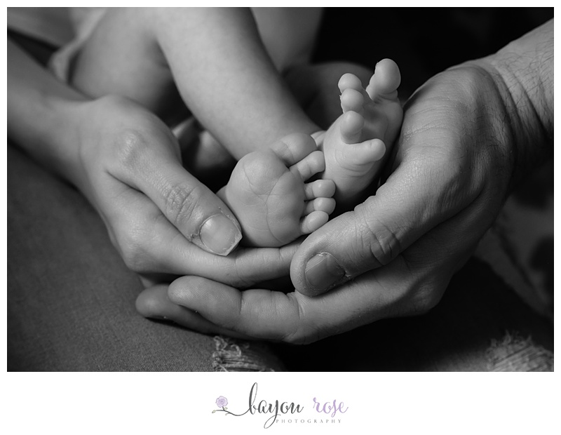 Baton Rouge Baby Photographer Lifestyle Newborn image of parents holding newborn baby's feet