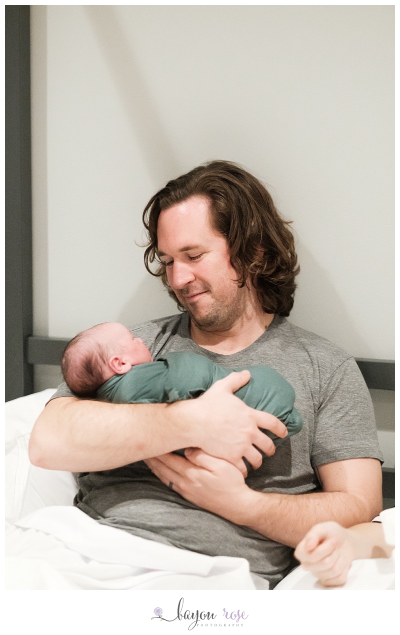father holding newborn baby boy