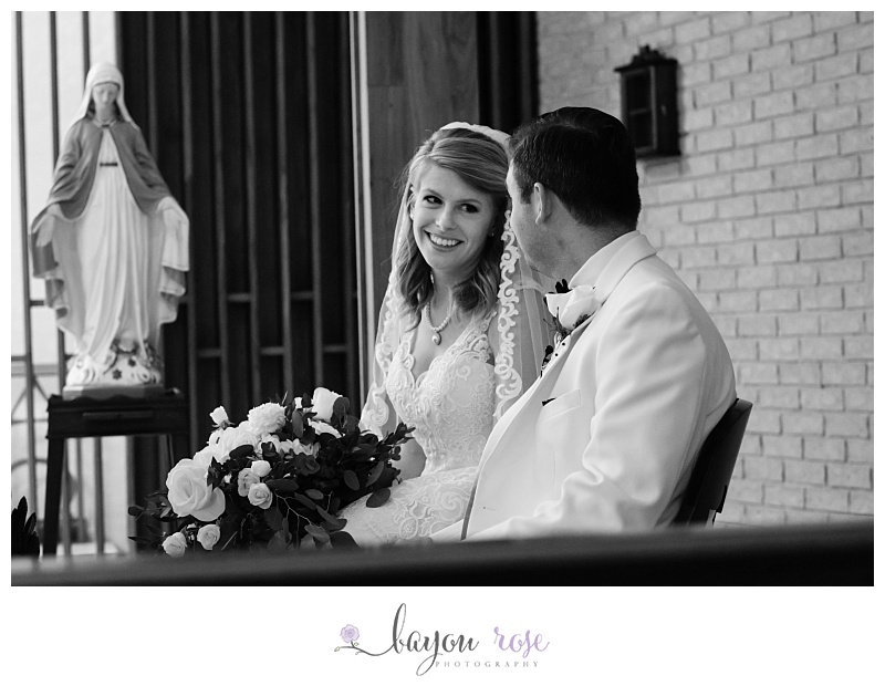 bride glances at groom during Catholic wedding ceremony at St Joseph