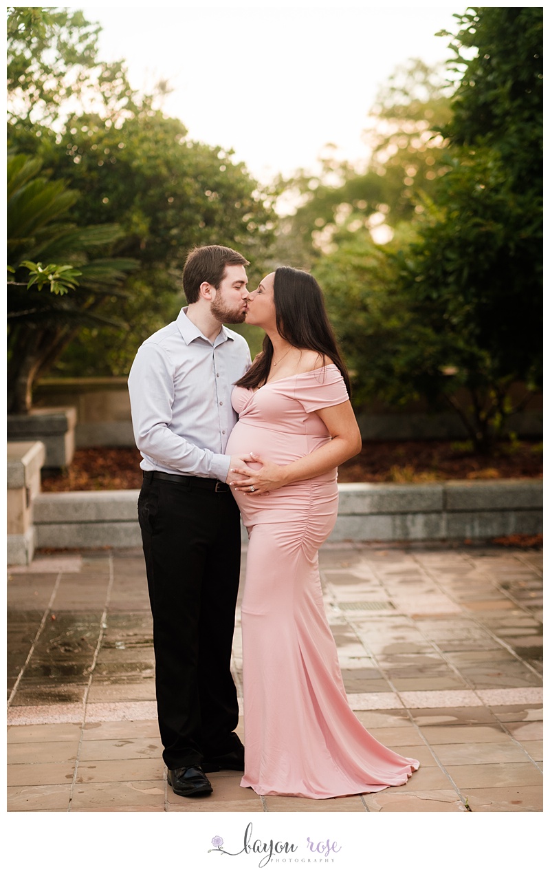 mom and dad kissing in maternity photo