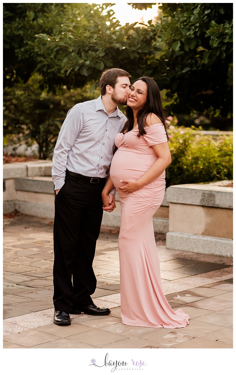 dad kissing mom on the cheek in Baton Rouge maternity photographer photo