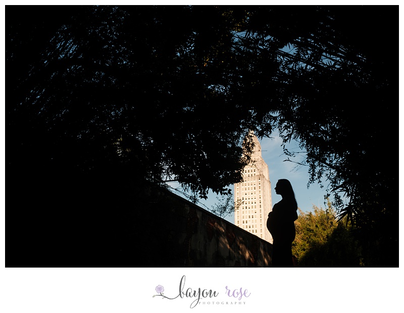 Maternity photo of mom silhouetted against Baton Rouge capitol