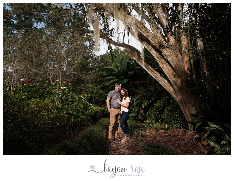 Engagement photo in garden under tree with Spanish moss