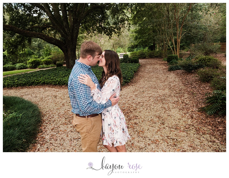 Couple kissing under oak tree at Windrush Gardens in Baton Rouge