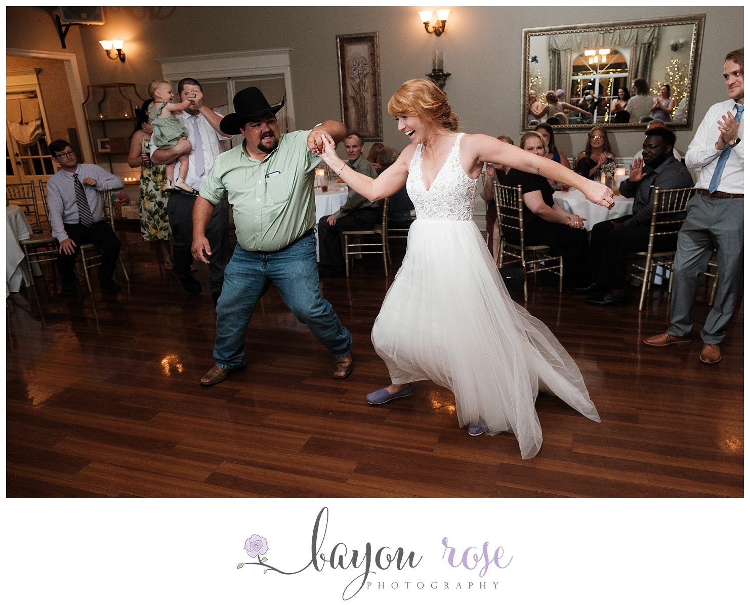 Bride is whirled around the dance floor during wedding reception