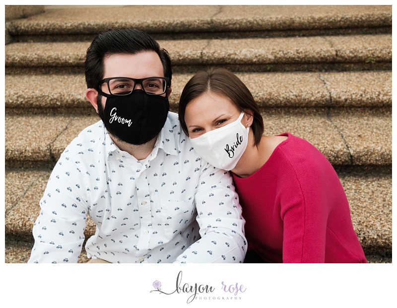 engaged couple wearing bride and groom masks