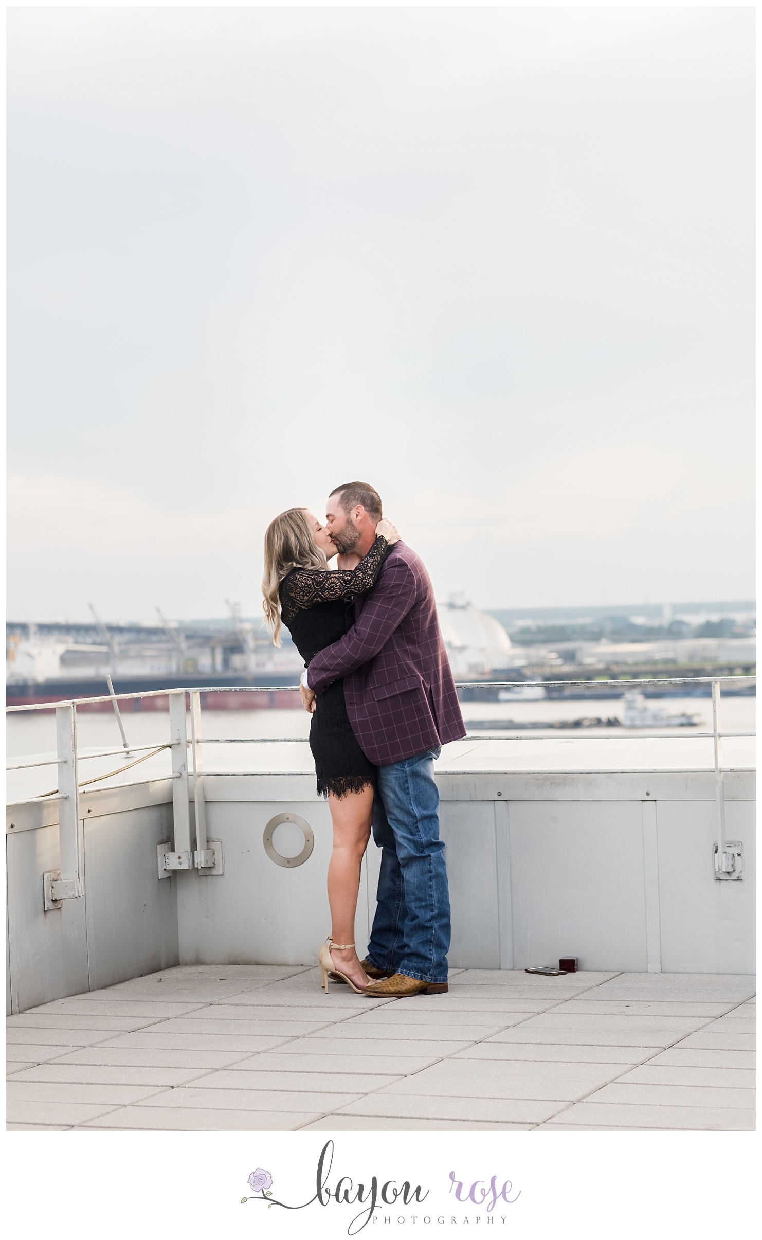 Couple kissing against the downtown Baton Rouge skyline