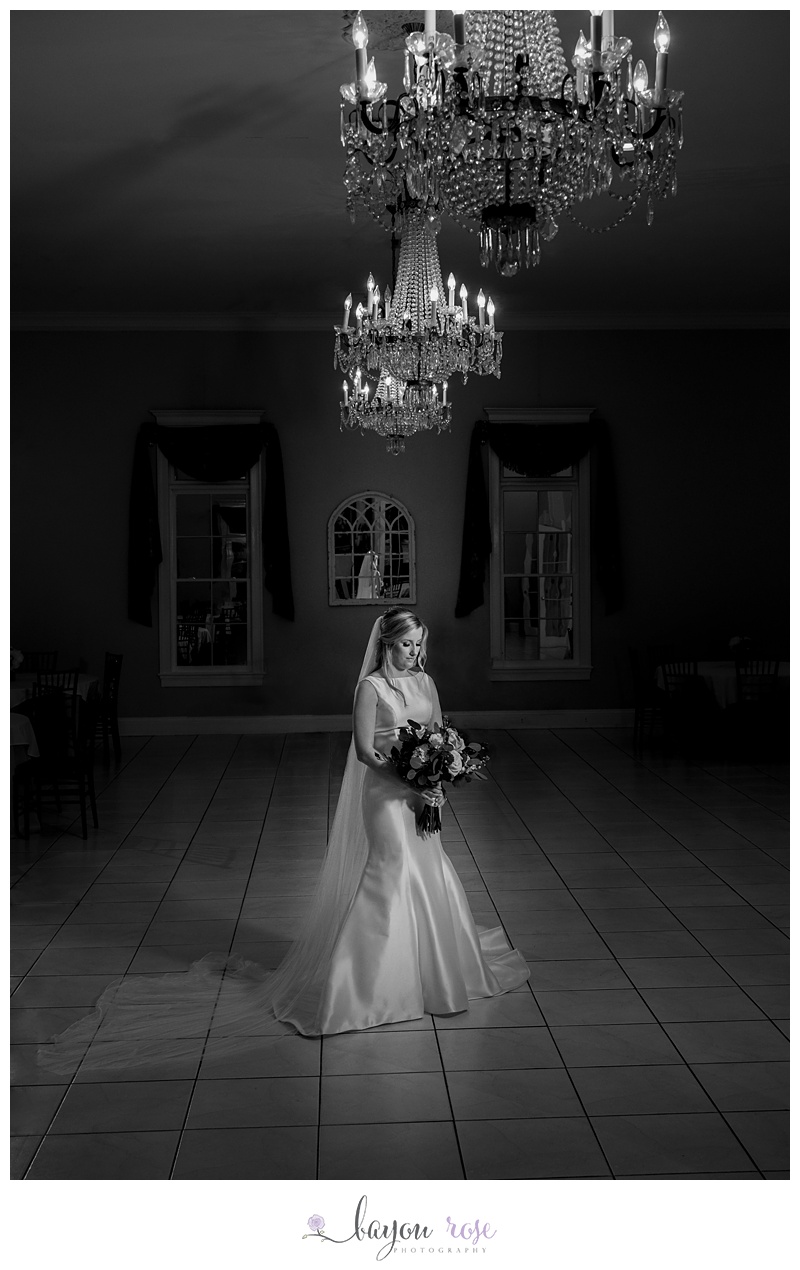 Bride under chandelier at Lake House Reception Center