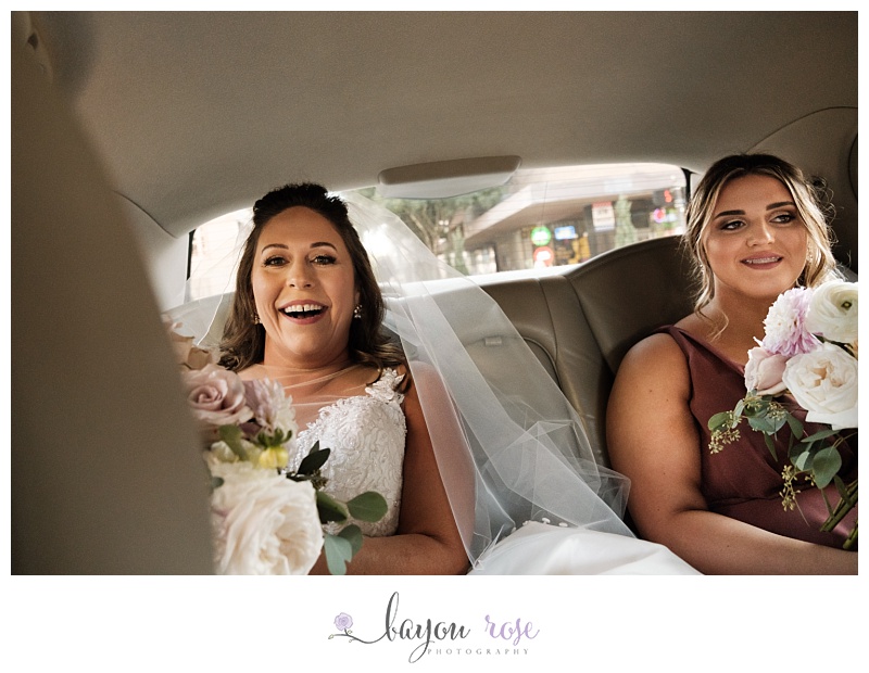 bride riding in car on the way to her wedding at Trademark Baton Rouge