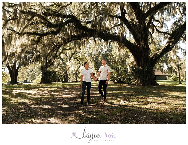 Gay men walking through park holding hands in New Orleans