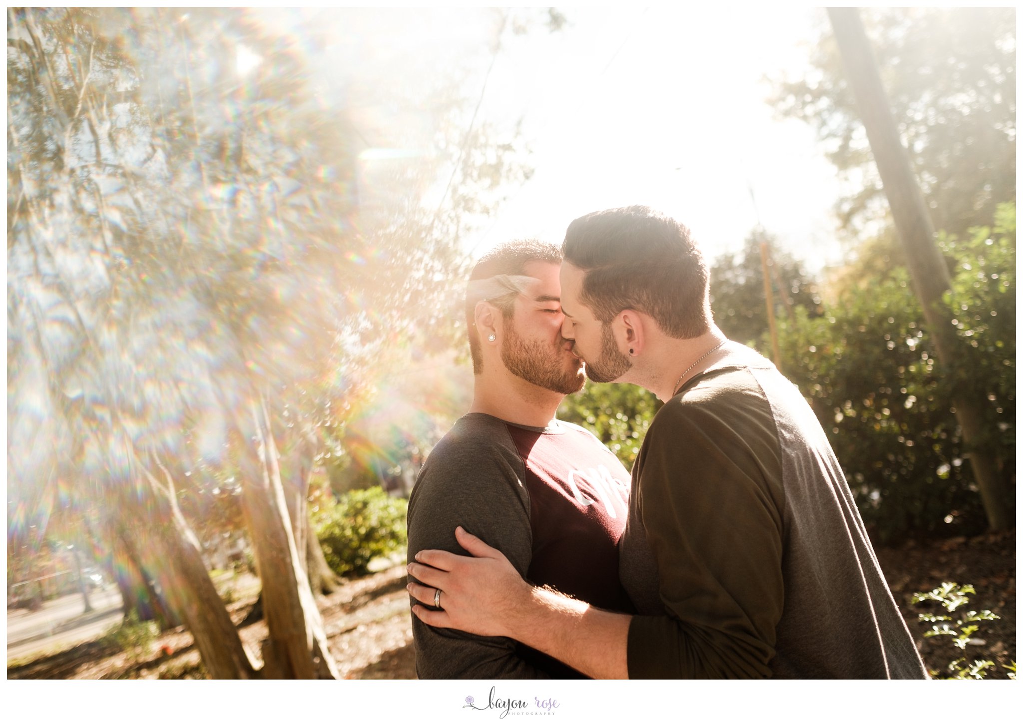 photo of two men kissing surrounded by reflections and rainbows