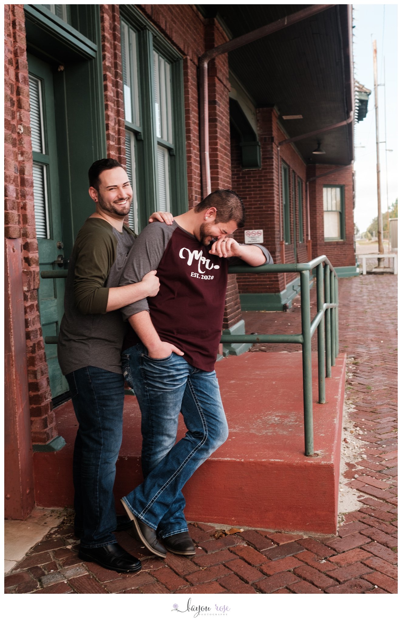 two guys laughing in a train station for wedding portraits