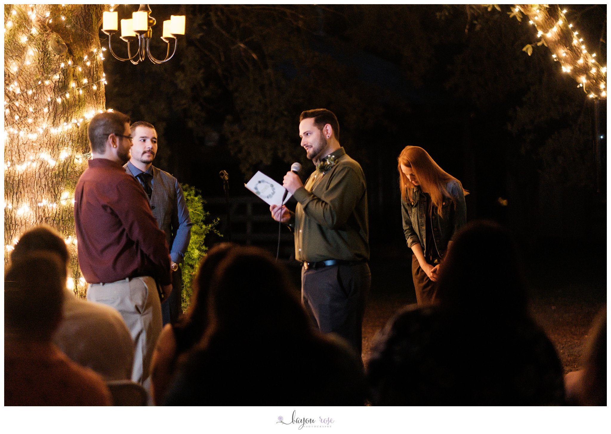 Gay wedding vows under an oak tree at night