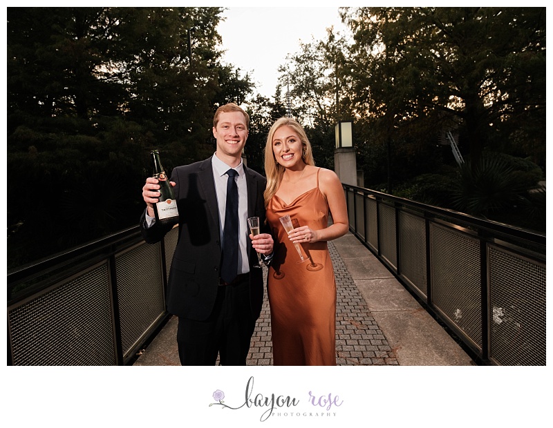 man and woman drinking champagne on bridge in Sculpture Garden