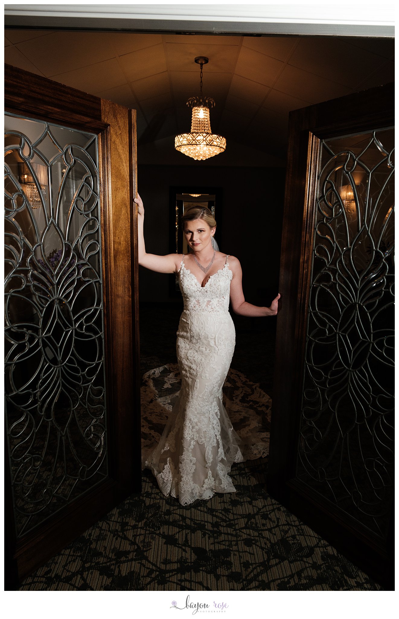 Bride under chandelier in doorway