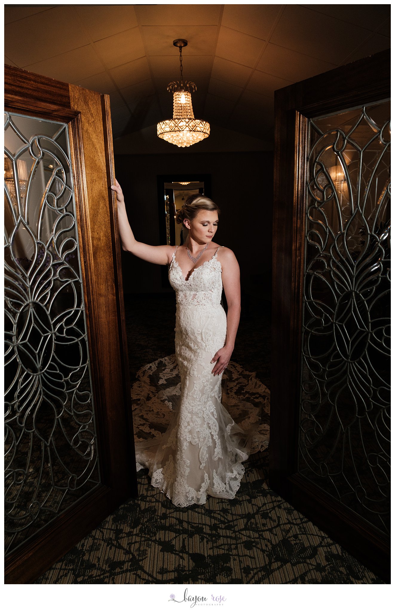 Bride posing in doorway of The Oaks for bridal photo session