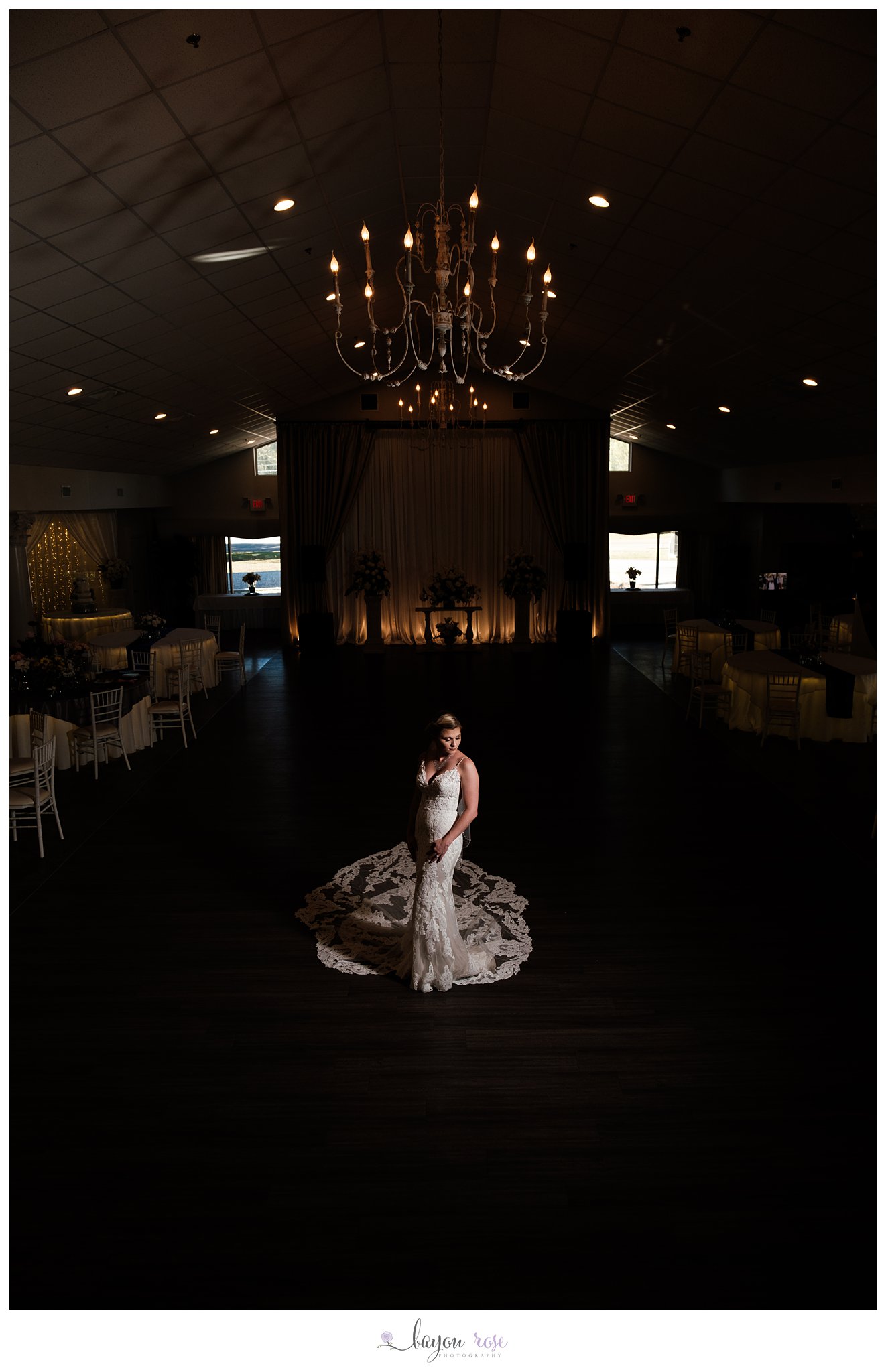 Bride posing under chandelier at The Oaks Ponchatoula wedding venue
