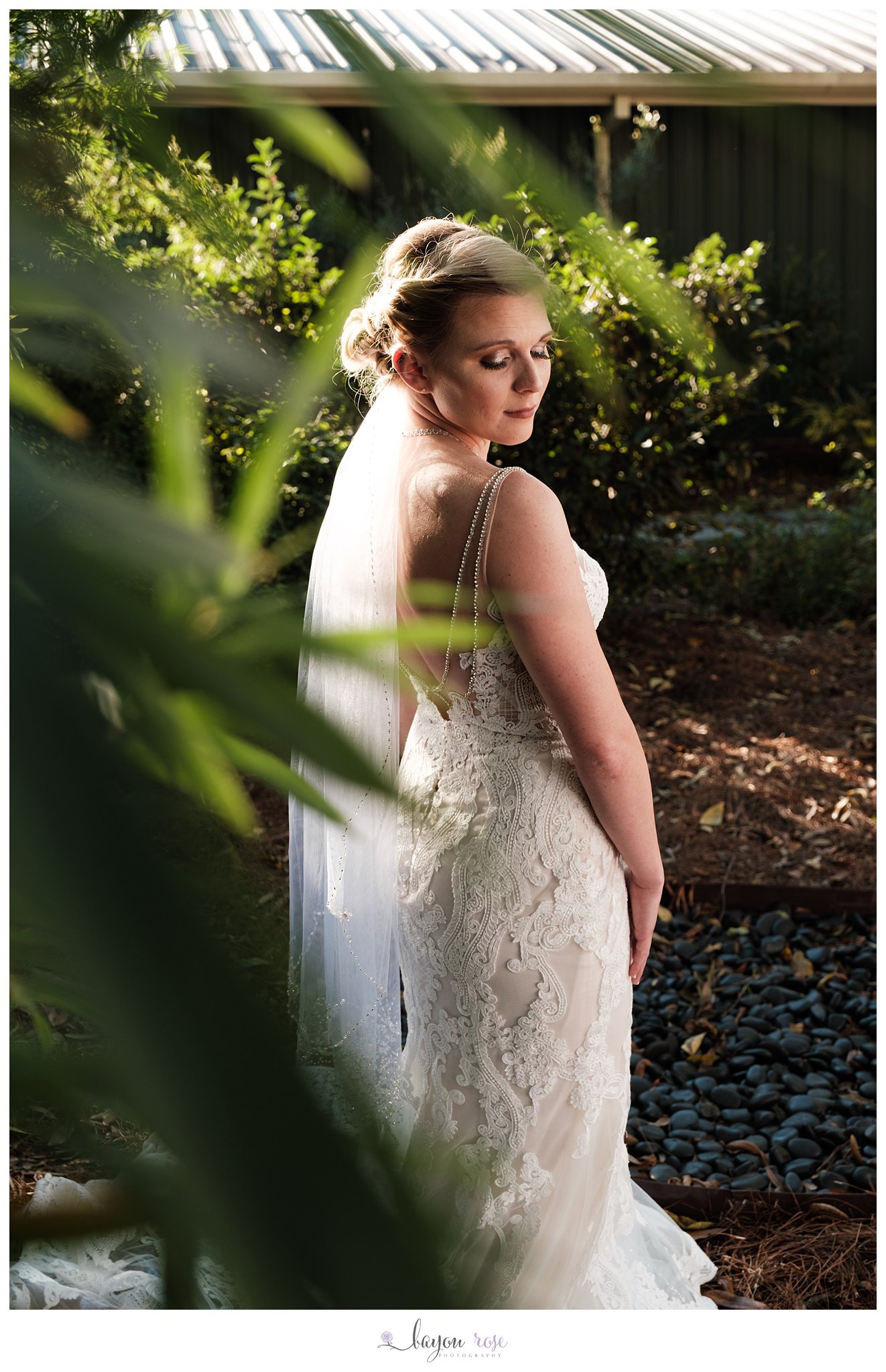 Bride framed by greenery at The Oaks outdoor bridal photo session