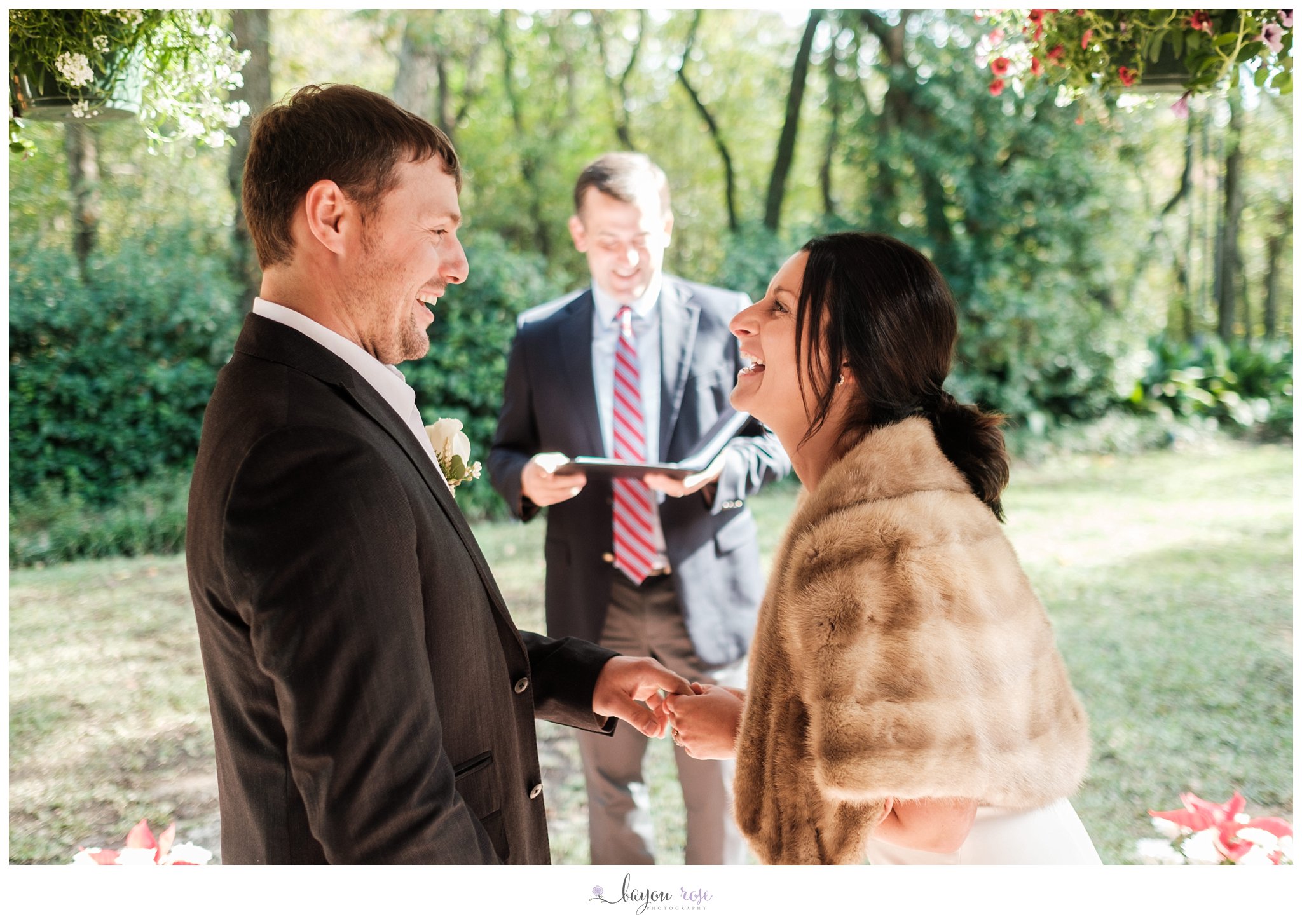 wedding couple laughing during back yard elopement wedding ceremony in Baton Rouge