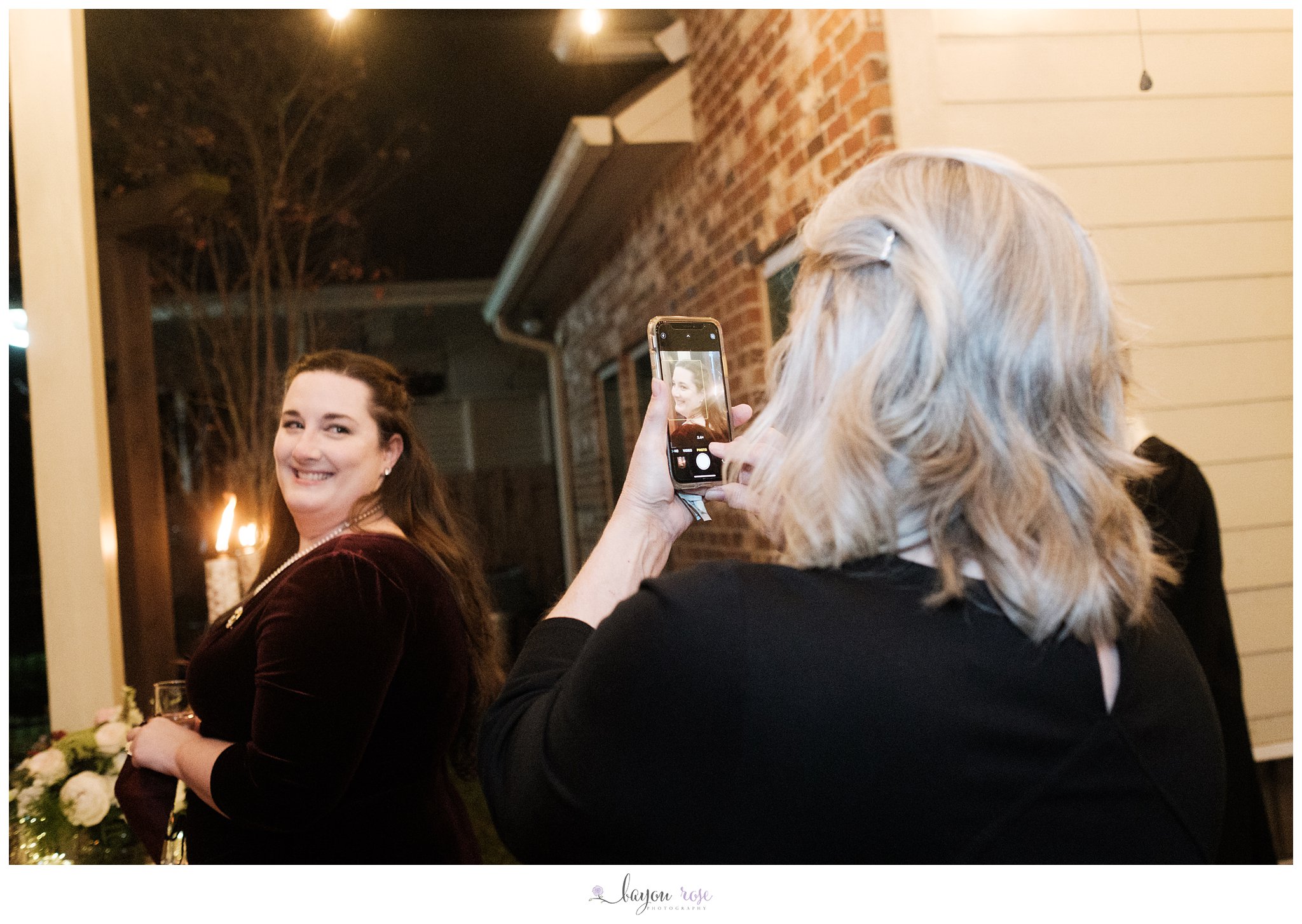 mother takes wedding day photo of bride