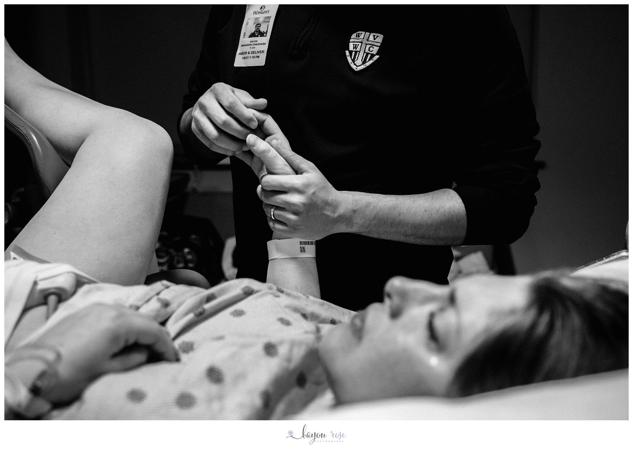 mom crying as dad holds her hand during labor