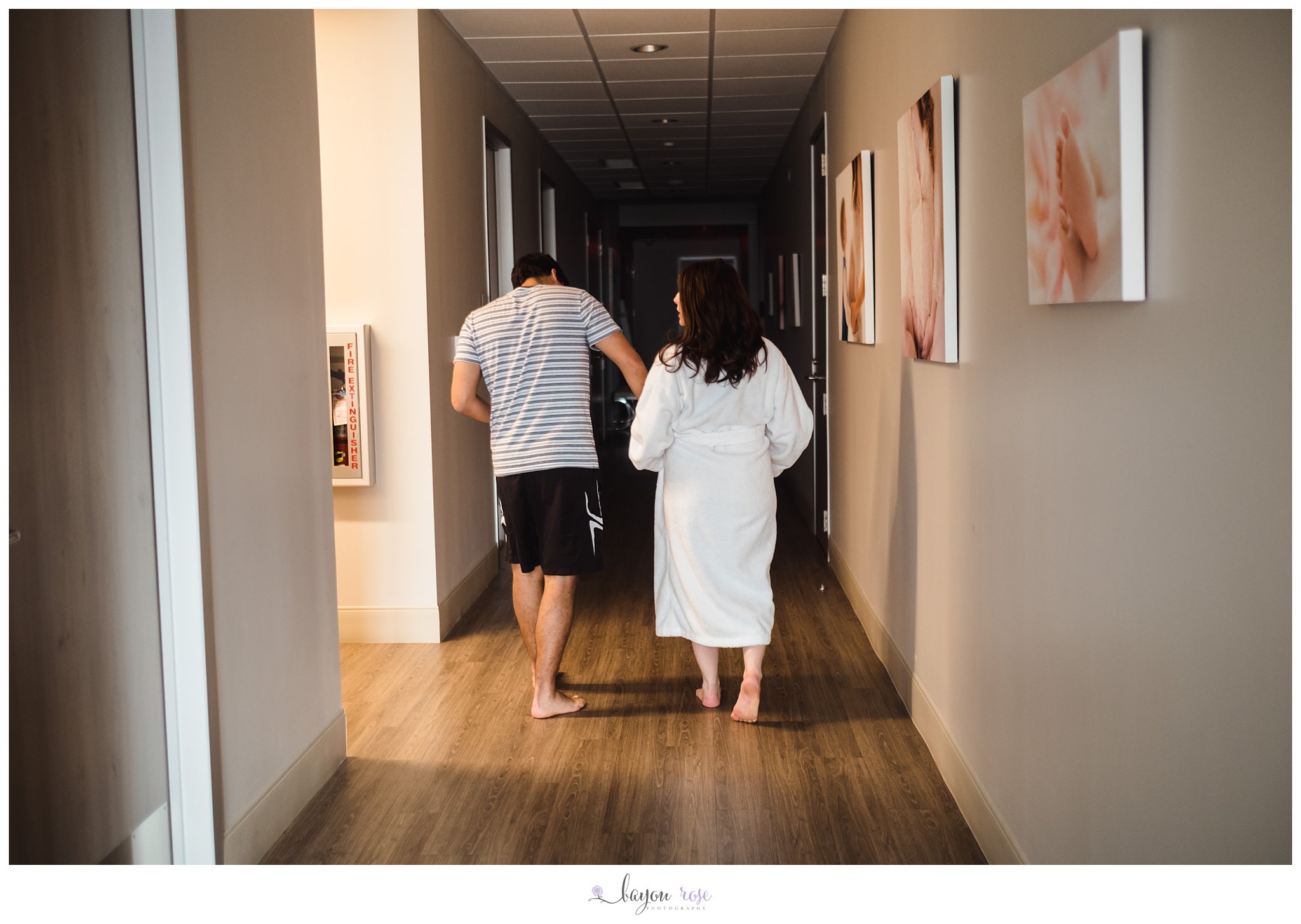 laboring mom walking down hallway with partner