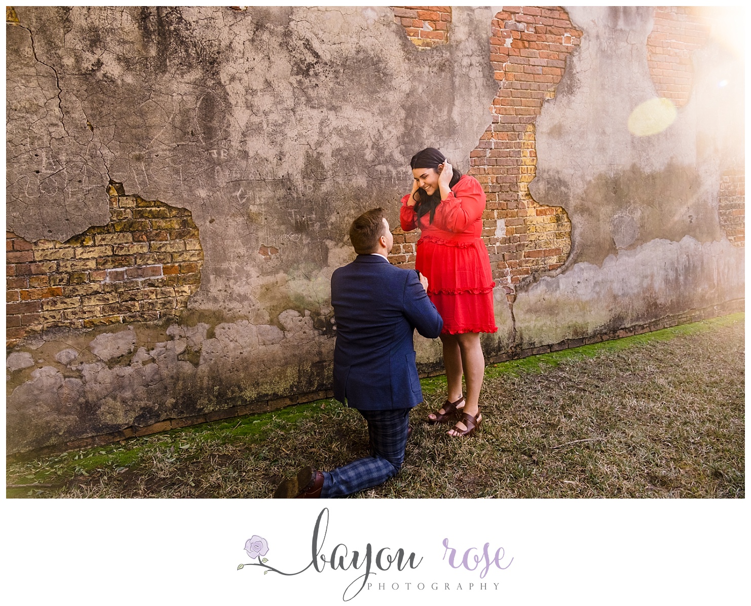 sun flare behind Baton Rouge armory as man proposes to his girlfriend