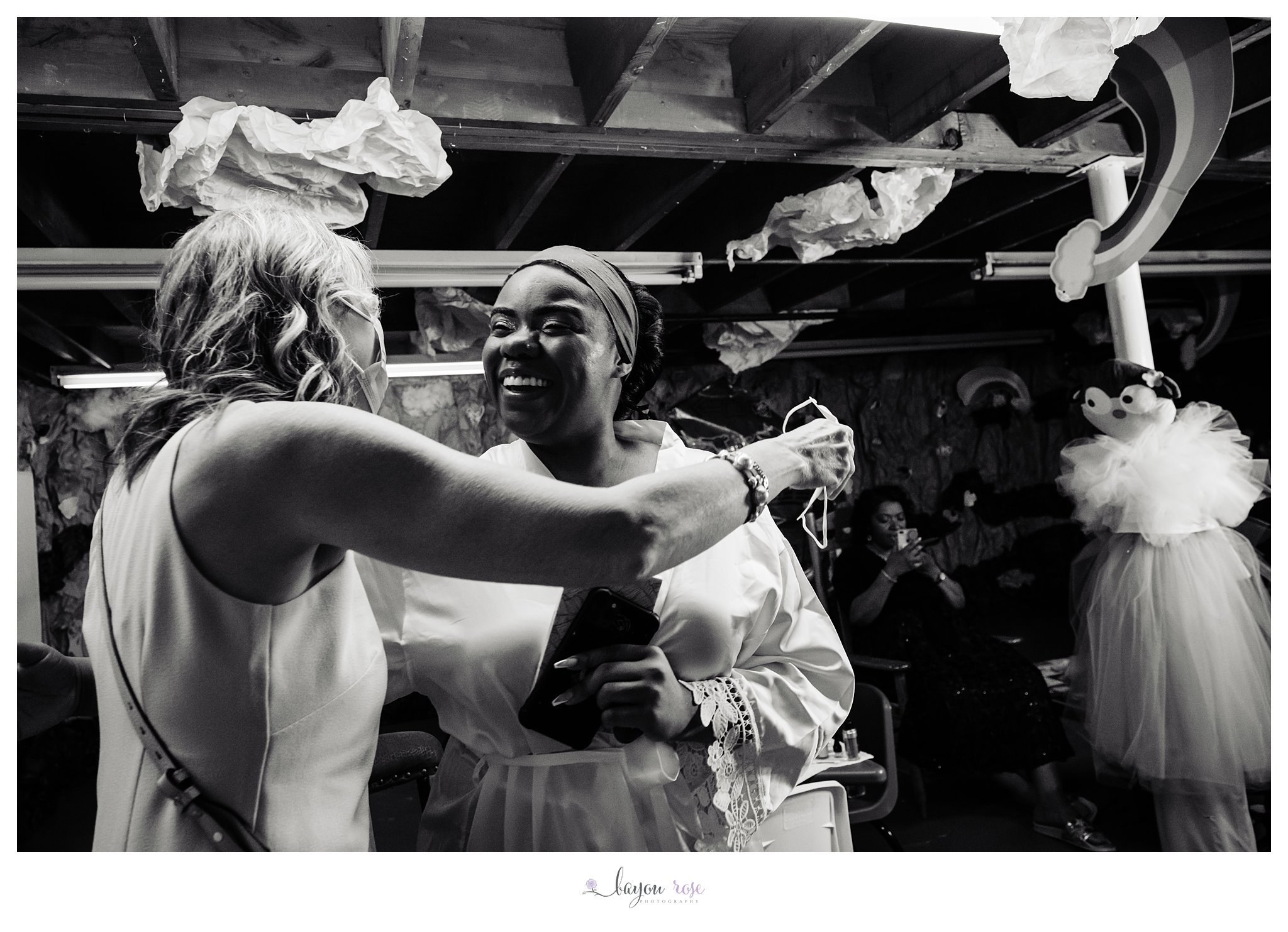 bride hugs mother in law while getting ready