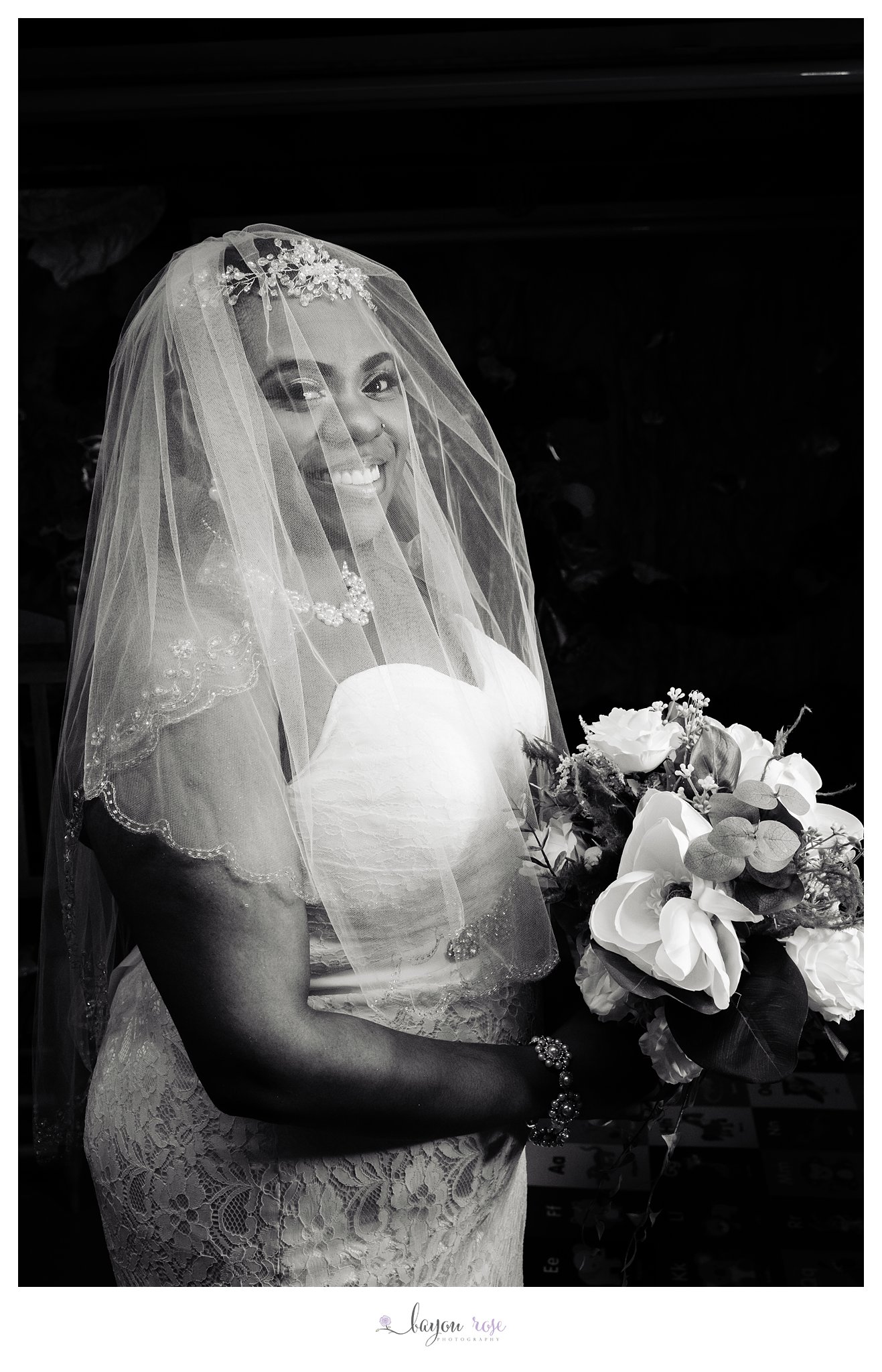 portrait of bride holding bouquet with veil