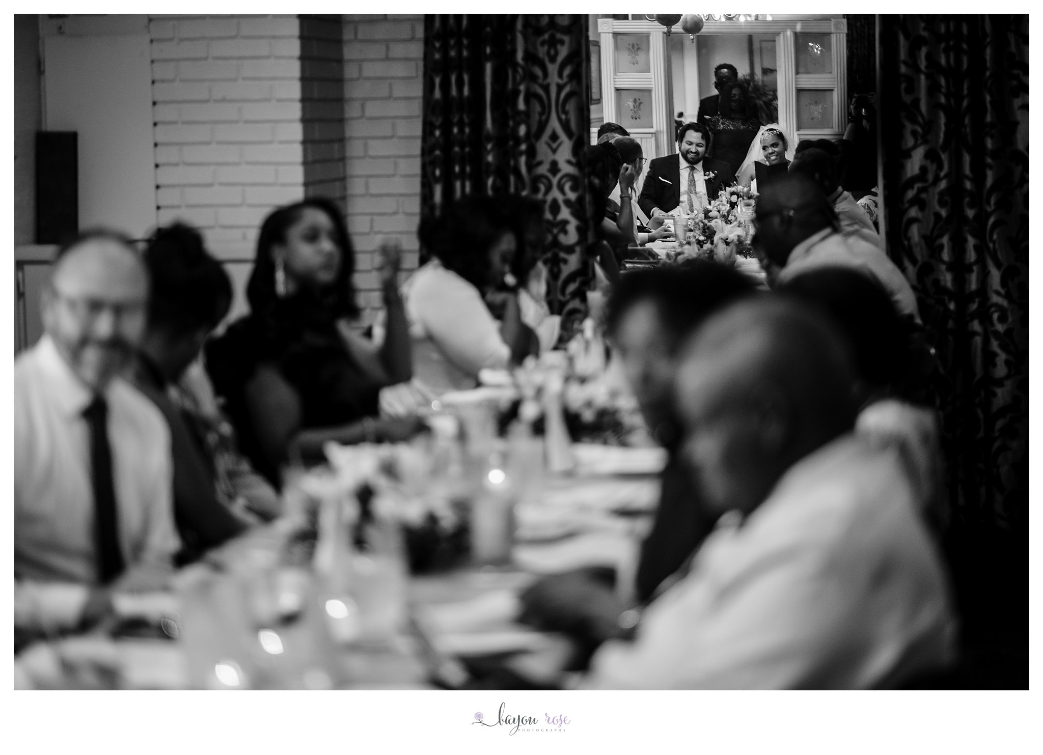 image of table filled with people at wedding reception in restaurant