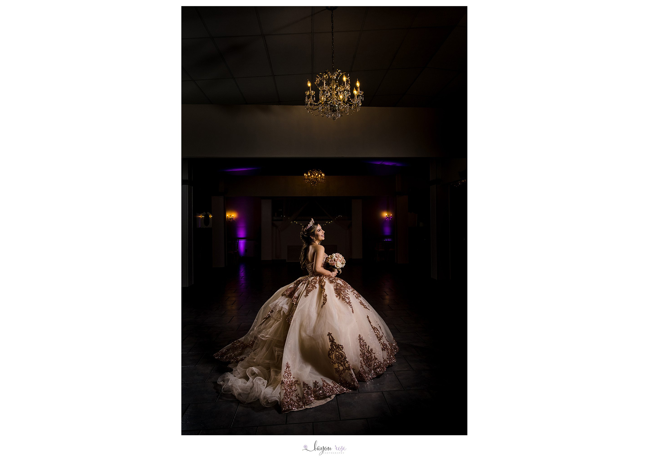 Girl posing in Quinceanera Dress under chandelier