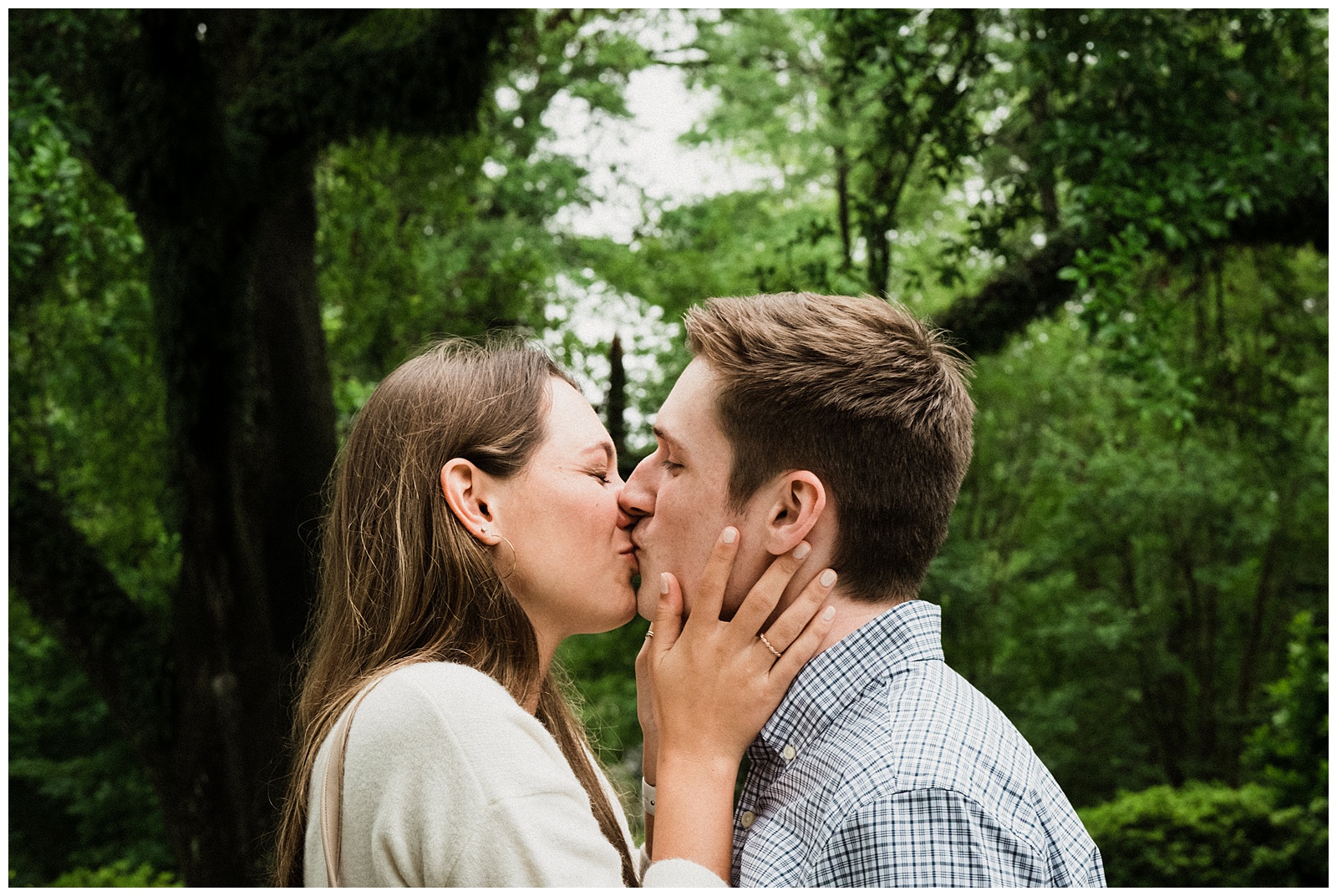 Newly engaged couple kisses