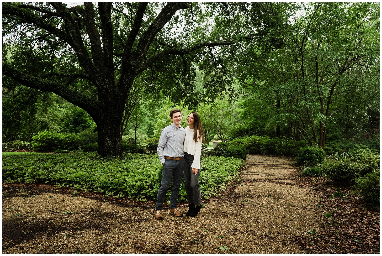 Couple laughing under tree at Windrush Gardens in Baton Rouge