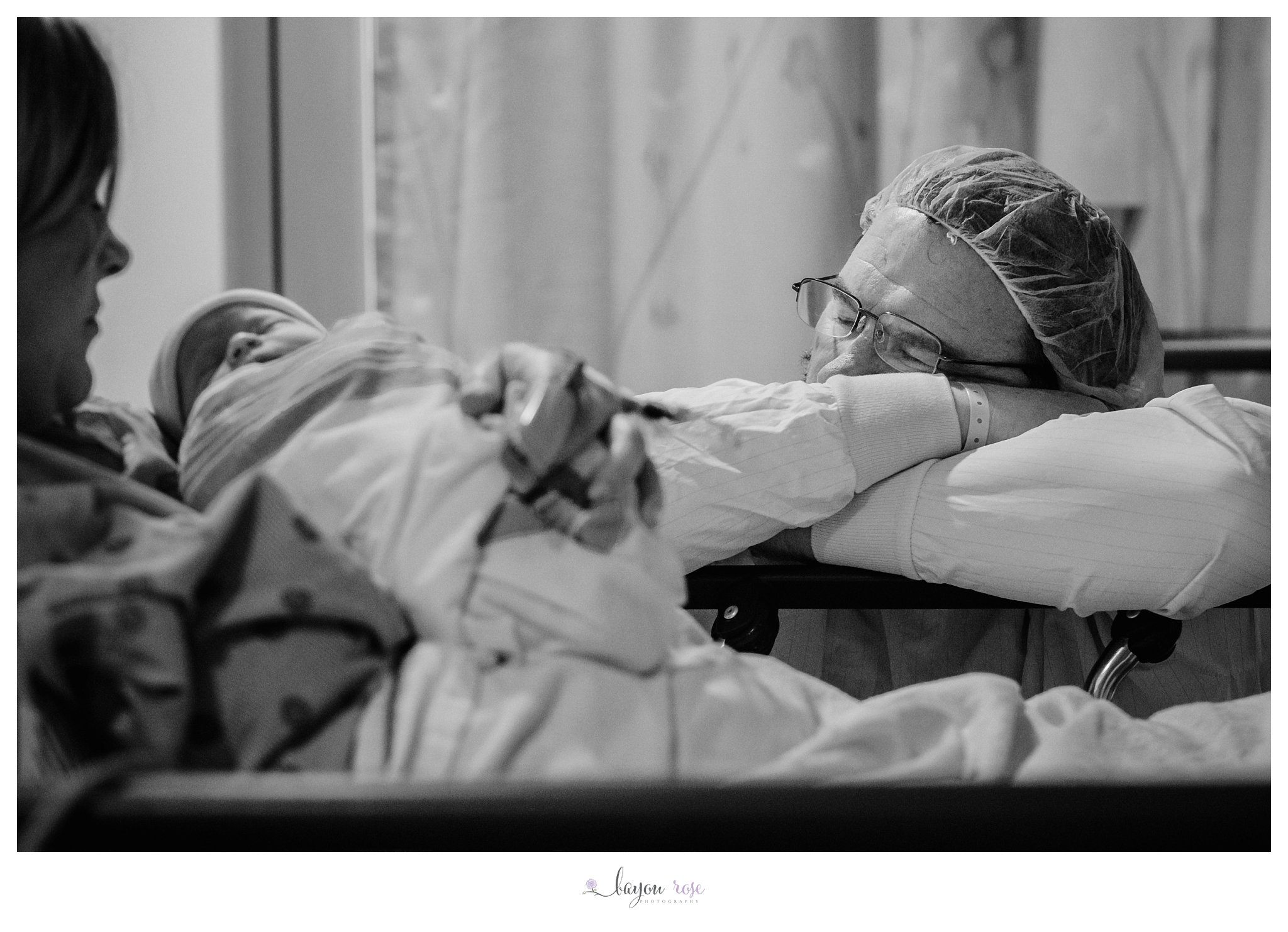 father in hospital cap falling asleep at mom's hospital bedside