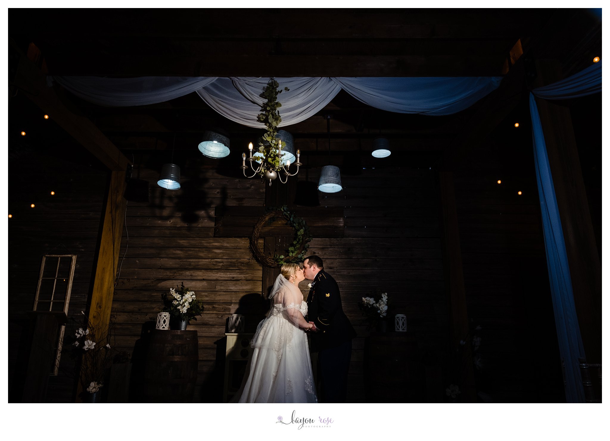 bride and groom kiss in Ashley Manor barn wedding
