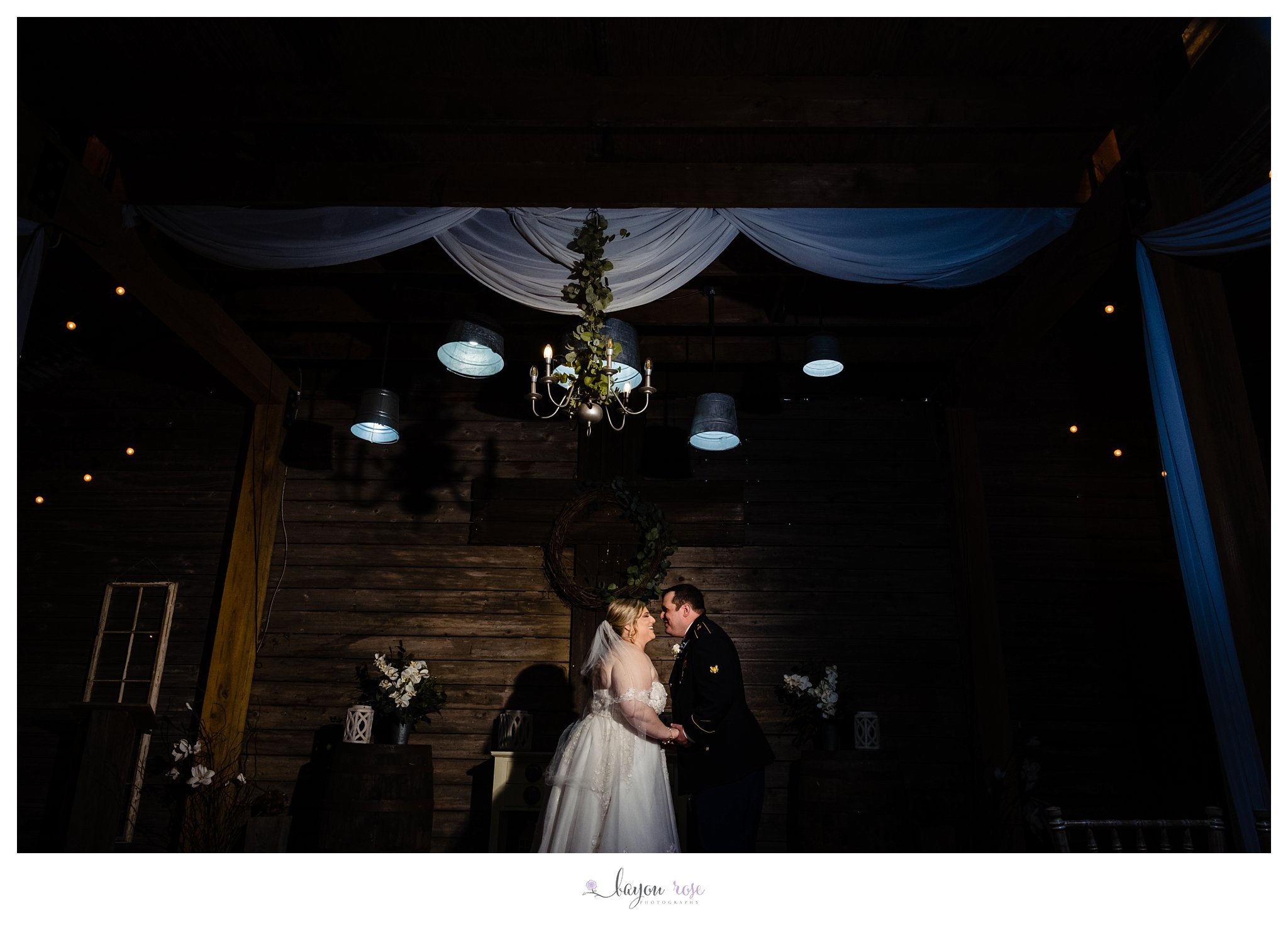 bride and groom kissing at Ashley Manor barn wedding