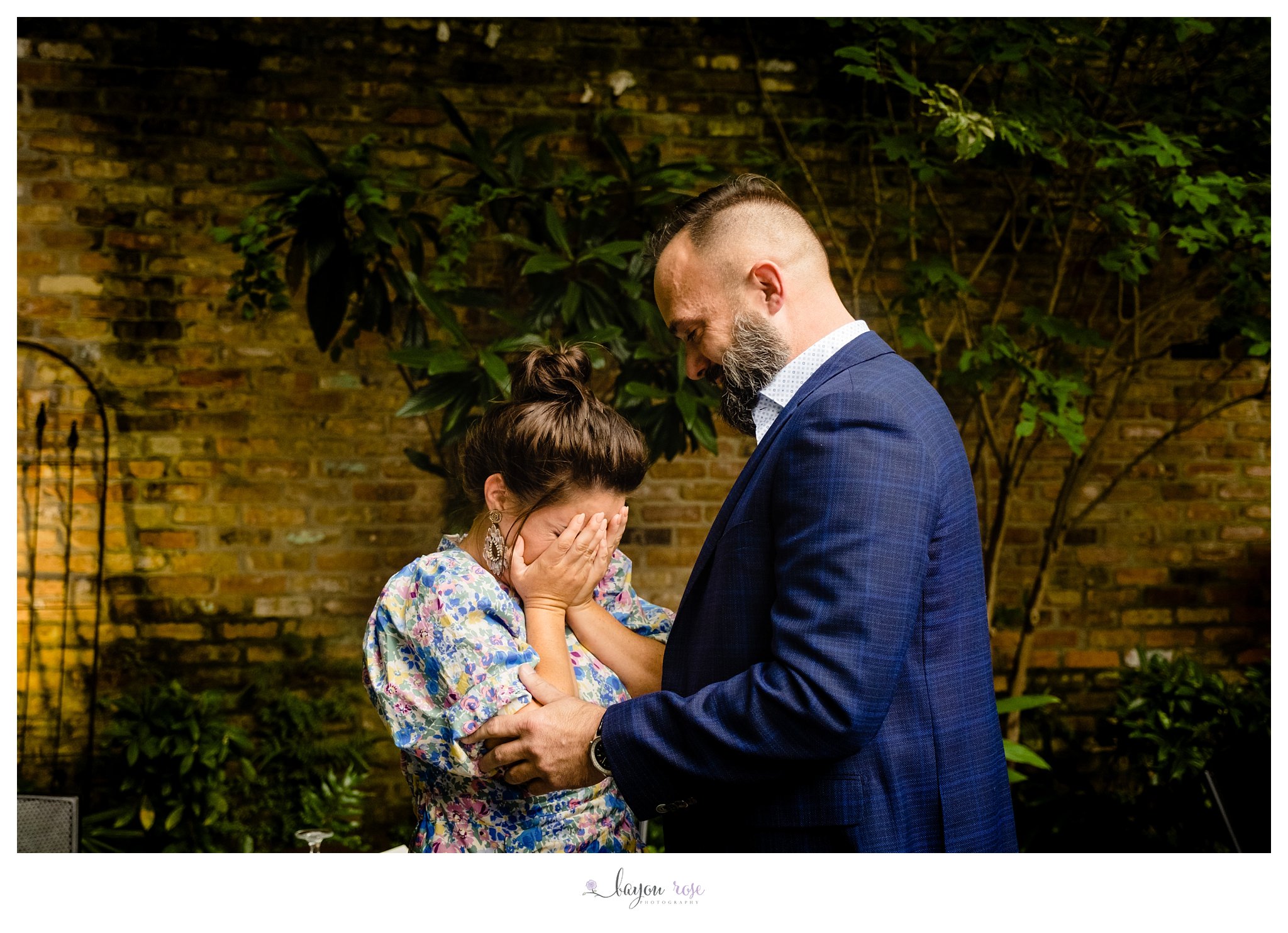 woman covers face in shock during surprise proposal photography session