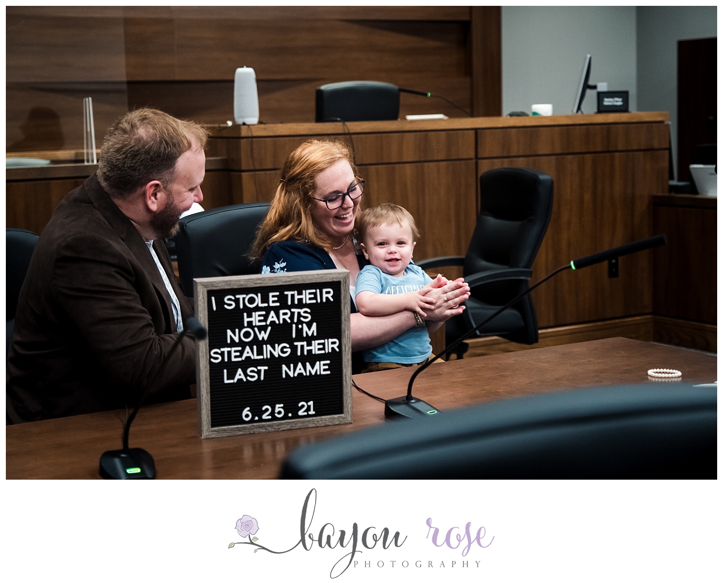 baby clapping on adoption day behind adoption sign