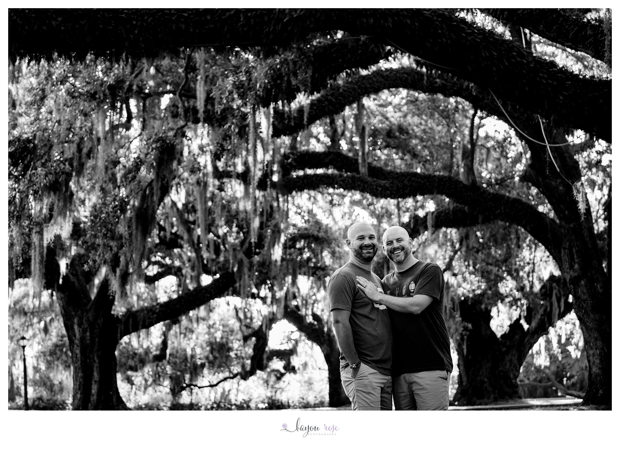 black and white engagement photo of two men in City Park New Orleans