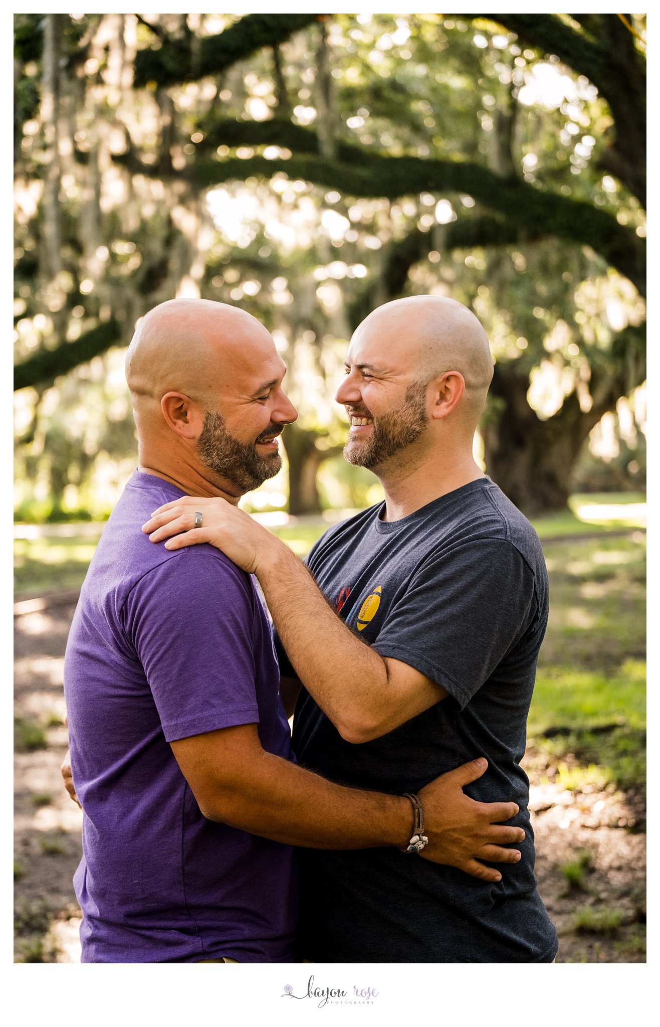 male couple laughing during engagement photo session in New Orleans