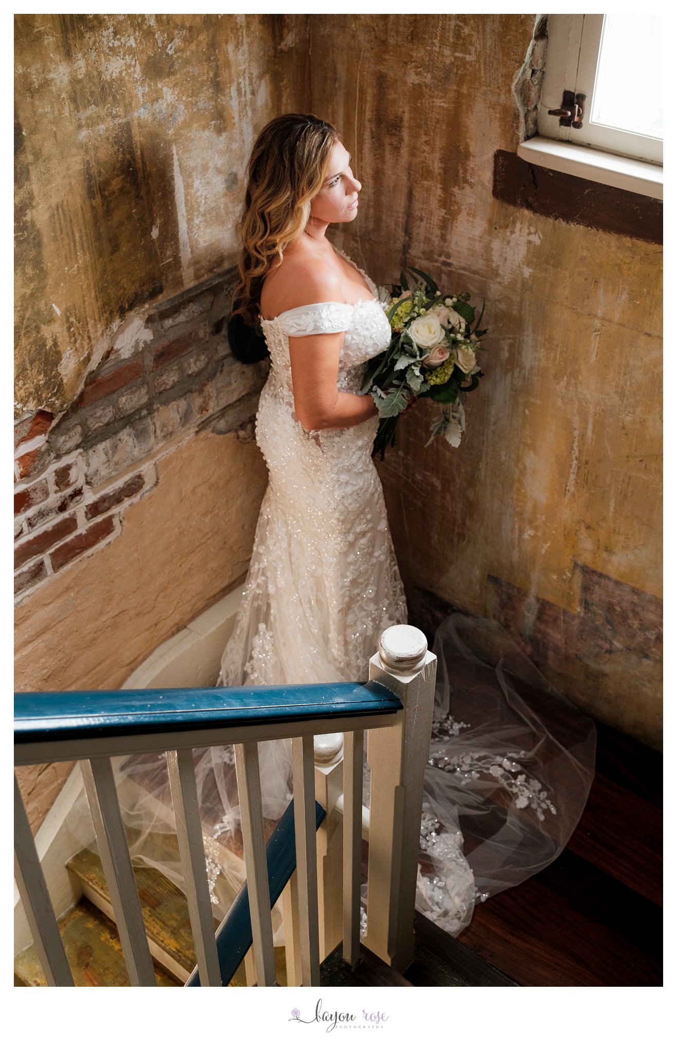 bride on staircase against exposed brick in New Orleans
