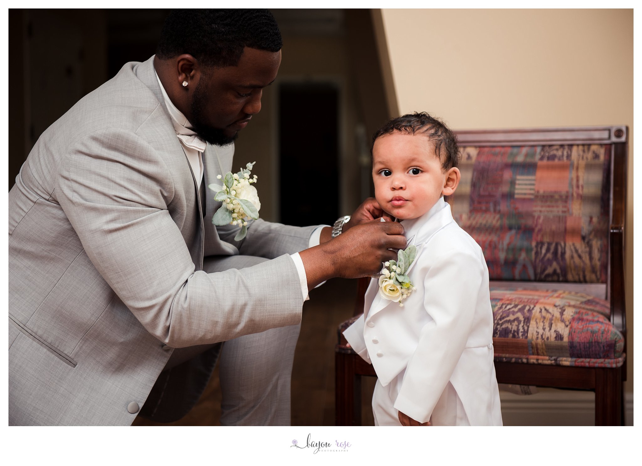 bride and groom's son getting dressed on wedding day