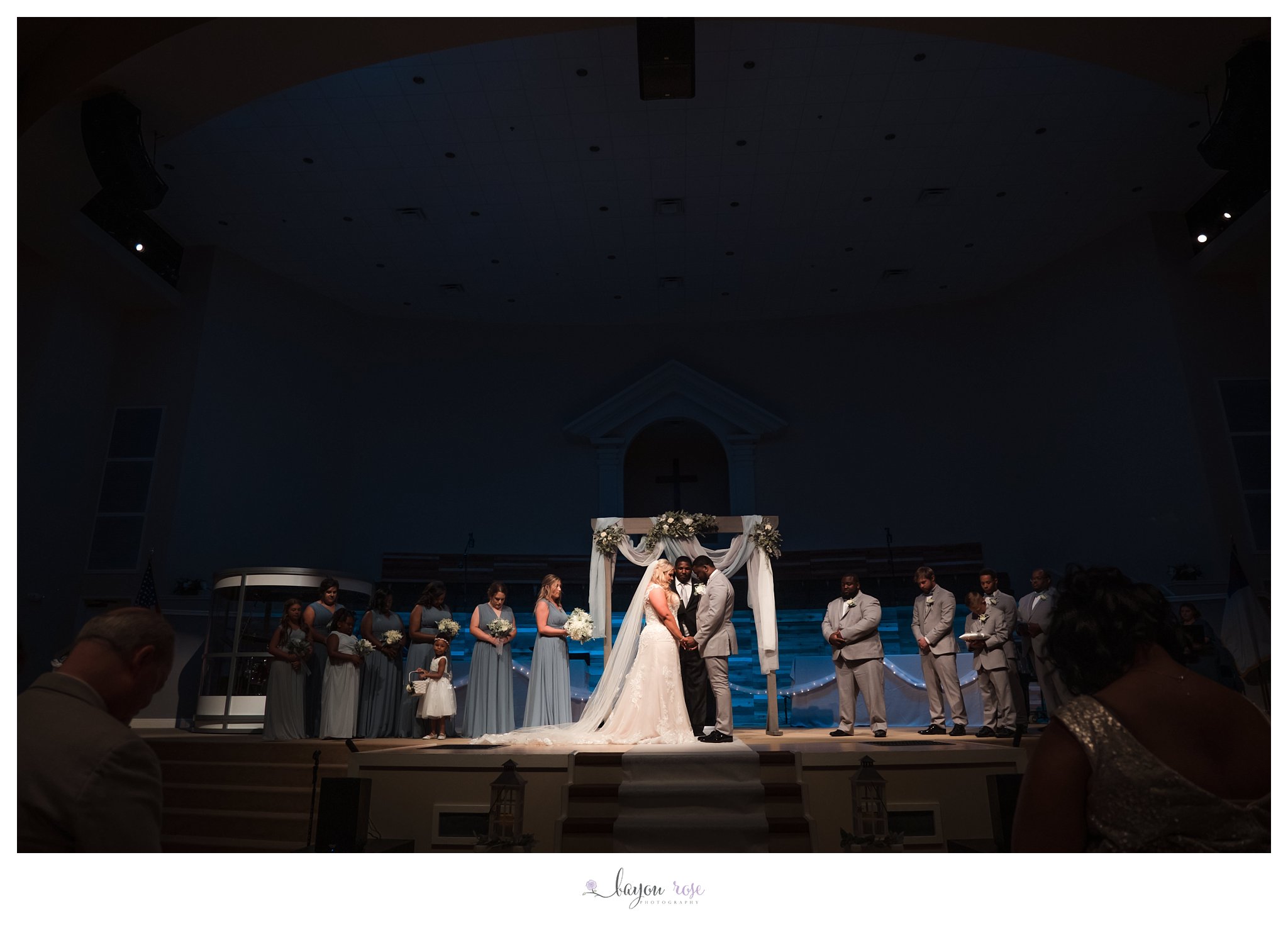 dramatic light wedding ceremony photo at Greenwell Springs Baptist Church
