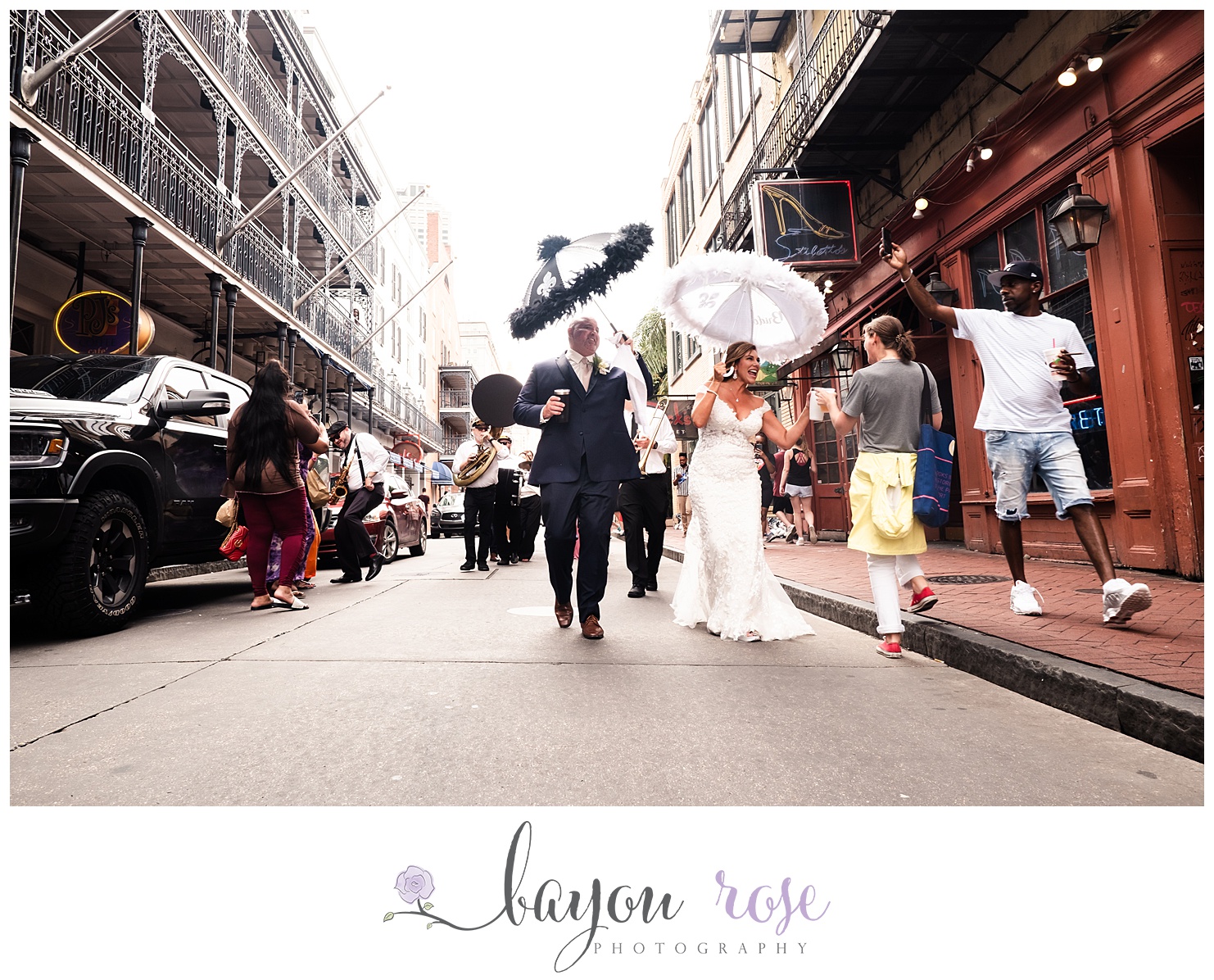 bride and groom toasting with strangers during New Orleans second line
